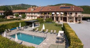 an aerial view of a house with a swimming pool at Cascina Rocca Agriturismo B&B in La Morra