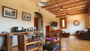 a living room with a table and chairs in a room at Apartamento El Pepito in Granollers