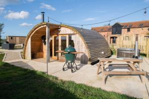 a circular shed with a table and a picnic table at Glamping Pod 3 Harmony in Scarborough