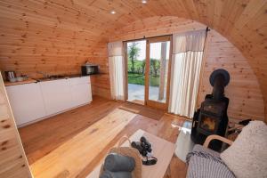 a living room with a woodburning stove in a cabin at Glamping Pod 5 Shelter in Scarborough