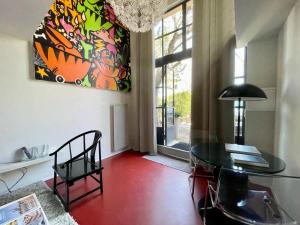 a dining room with a glass table and a chandelier at Loft 52 in Aix-en-Provence