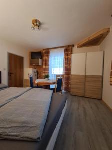 a bedroom with a bed and a table and chairs at Haus Maria Wallinger in Abtenau