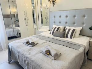 a bedroom with a large bed with towels on it at Costa Adeje Orlando Tenerife Sea View - Pool - AC in Adeje