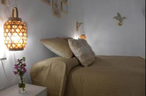 a bedroom with a bed and two pillows on it at Precioso loft en pleno centro histórico de Vejer in Vejer de la Frontera