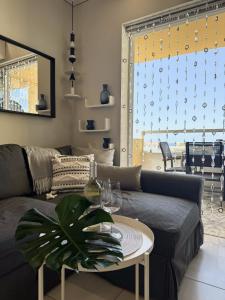 a living room with a couch and a table at Costa Adeje Orlando Tenerife Sea View - Pool - AC in Adeje