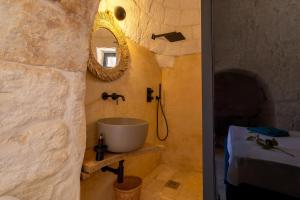 a bathroom with a sink and a mirror at Trullo con vista mare e piscina riscaldata in Carovigno