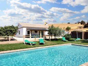 a villa with a swimming pool in front of a house at 7 bedrooms villa with private pool enclosed garden and wifi at Prado del Rey in Prado del Rey