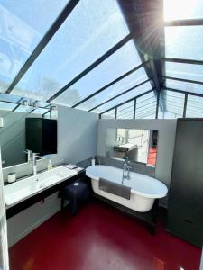 a large bathroom with a large tub and a sink at Loft 52 in Aix-en-Provence