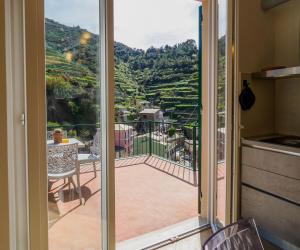 a sliding glass door with a view of a patio at Macaia Family Apartment with AC in Vernazza