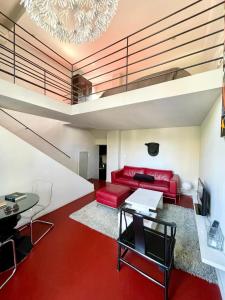 a living room with a red couch and a table at Loft 52 in Aix-en-Provence