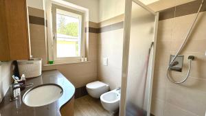 a bathroom with a sink and a toilet and a shower at S334 - Sirolo, meraviglioso trilocale panoramico in Sirolo +8 photos