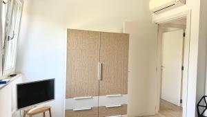 a large cabinet with a television in a room at S334 - Sirolo, meraviglioso trilocale panoramico in Sirolo