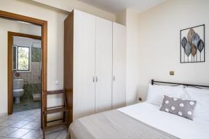a bedroom with a bed and a bathroom at Villa Nina with Private Plunge Pool, 5km to Corfu Town in Corfu Town