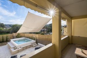 a swimming pool on the balcony of a house at Villa Nina with Private Plunge Pool, 5km to Corfu Town in Corfu Town