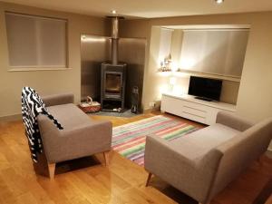 a living room with a couch and a fireplace at The Annex, The Moors House in South Zeal