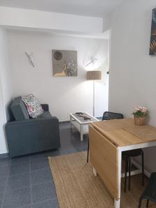 a living room with a couch and a table at La Campanilla-Suances in Suances