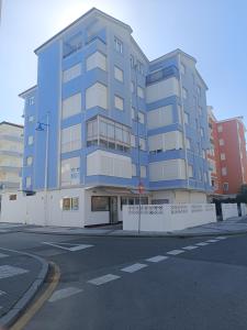 a blue building on the corner of a street at La Campanilla-Suances in Suances
