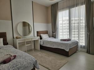 a hotel room with two beds and a mirror at Sea View 2-Bedroom Apartment with Water Park at Caesar Blue Resort in Boğaz