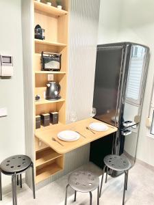 a kitchen with a table and two chairs and a refrigerator at Estudio Regenta Con Parking privado in Oviedo +27 photos
