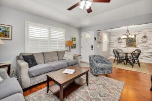 a living room with a couch and a table at The Squeezebox in Saint Simons Island