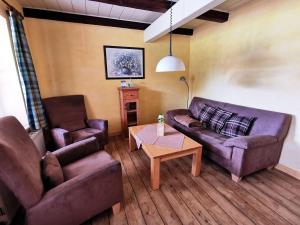 a living room with a couch and two chairs and a table at Ferienwohnung-Kornkammer in Presen