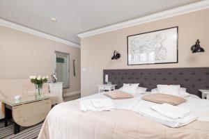 a white bedroom with a large bed with white sheets at Villa Astra Baltica in Międzyzdroje +120 photos