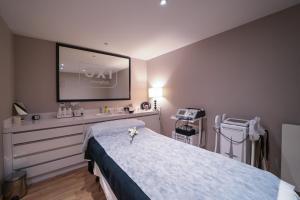 a hospital room with a bed and a tv at Aparthotel AnyosPark Mountain & Wellness Resort in Anyós