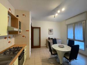 a kitchen with a table and a small table and chairs at Forte Marghera 119 in Venice