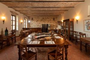 a large dining room with a large wooden table at Cascina Rocca Agriturismo B&B in La Morra
