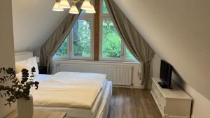 a bedroom with a bed and a large window at Ellernhof in Dahlenburg