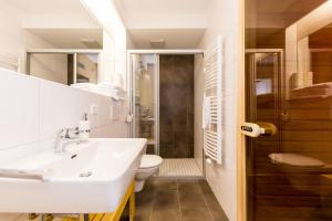 a bathroom with a sink and a toilet at Sissi Park Haus im Ennstal in Haus im Ennstal