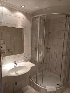 a bathroom with a shower and a sink at Hotel Grünwaldkopf in Obertauern