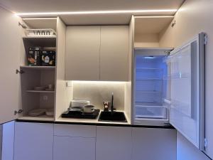 uma cozinha branca com um lavatório e um fogão em Templa One by Gloove em Múrcia