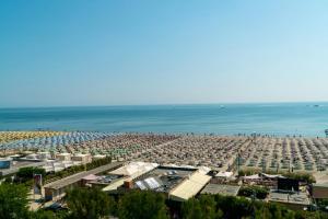 a beach with a lot of people and the ocean at Hotel Brasil Pool & Spa in Milano Marittima