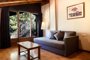 a living room with a couch and a table at Aparthotel AnyosPark Mountain & Wellness Resort in Anyós