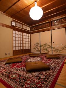 a room with a large rug on the floor at HOSTEL KURIYA OSAKA in Izumi-Sano
