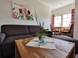 a living room with a couch and a table at Ferienwohnung-Apfelbluete in Presen