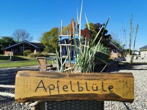 a wooden sign that reads agriculture in a yard at Ferienwohnung-Apfelbluete in Presen