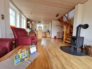 a living room with a wood stove in a house at Doppelhaushaelfte-Klatschmohn in Presen