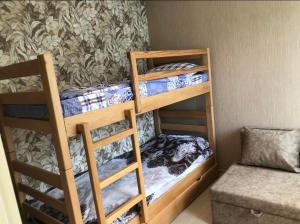 a bunk bed room with two bunk beds and a couch at Bakuriani Park Recidence Apartment in Bakuriani +7 photos