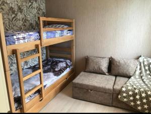 a small room with bunk beds and a couch at Bakuriani Park Recidence Apartment in Bakuriani