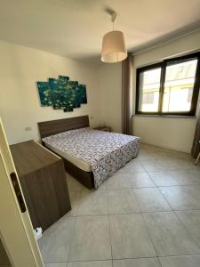 Ένα ή περισσότερα κρεβάτια σε δωμάτιο στο Ferienhaus Residenz Capo Nord Aprilia Marittima bei Lignano , Via Capo Nord 5 Haus 42