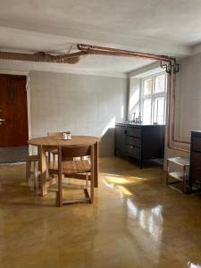 an empty room with a table and a kitchen at Nordic Design Residency / Natural habitat in Copenhagen