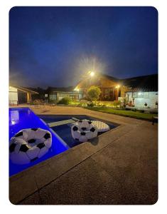 a backyard with a swimming pool at night at Quinta Suria in Quito