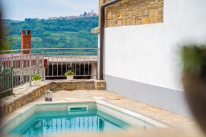 a swimming pool on the side of a building at Holiday Home Belveder Motovun with heated pool in Livade