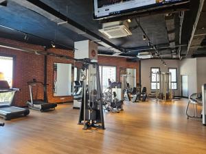 a gym with several treadmills and machines in a room at Sea View 2-Bedroom Apartment with Water Park at Caesar Blue Resort in Boğaz