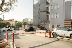 a parking lot with cars parked in front of a building at Maritan Hotel & Spa in Padova