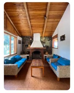 a living room with blue couches and a fireplace at Quinta Suria in Quito