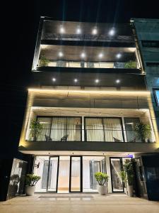 a building with two balconies and potted plants on it at The Lodgers 2 BHK Serviced Apartment Near Artemis Hospital Sector 57 Gurgaon - Nearest Metro Station Sector 54 Chowk in Gurgaon