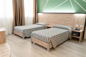 מיטה או מיטות בחדר ב-Maritan Hotel & Spa